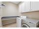 Bright laundry room with washer, dryer, and ample storage at 25807 N 19Th Gln, Phoenix, AZ 85085