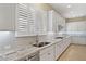 Clean kitchen with white cabinets, granite countertops and stainless steel dishwasher at 25807 N 19Th Gln, Phoenix, AZ 85085