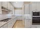 Bright kitchen with white cabinets, granite countertops and gas cooktop at 25807 N 19Th Gln, Phoenix, AZ 85085