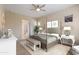 Main bedroom with post bed, neutral decor and ensuite bathroom at 25807 N 19Th Gln, Phoenix, AZ 85085