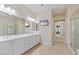 Elegant bathroom with double vanity, large mirror, and walk-in shower at 25807 N 19Th Gln, Phoenix, AZ 85085