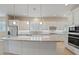 Modern kitchen featuring granite island, white cabinets, and stainless steel appliances at 25807 N 19Th Gln, Phoenix, AZ 85085