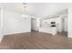 Open dining room with wood-look tile flooring and chandelier adjacent to kitchen at 16755 W Cameron Dr, Surprise, AZ 85388