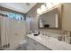 Clean bathroom with a white vanity, marble countertop, and a bathtub at 1391 N Alexis Dr, Gilbert, AZ 85234