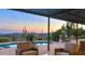 Sunset view from covered patio with pool and seating at 7150 E Sierra Vista Rd, Cave Creek, AZ 85331