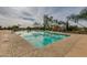 Inviting community pool with patio umbrellas at 2126 W Red Fox Rd, Phoenix, AZ 85085