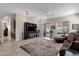 Spacious living room with a ceiling fan and access to patio at 2126 W Red Fox Rd, Phoenix, AZ 85085
