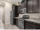 Modern kitchen with dark cabinetry and granite counters at 2126 W Red Fox Rd, Phoenix, AZ 85085