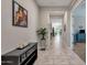Hallway with tile floors, view to living area, and decorative accents at 2126 W Red Fox Rd, Phoenix, AZ 85085