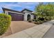 House exterior with a two-car garage and manicured landscaping at 2126 W Red Fox Rd, Phoenix, AZ 85085