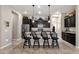 Island kitchen with granite countertops and dark cabinets at 2126 W Red Fox Rd, Phoenix, AZ 85085