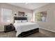 Main bedroom with plush bed and ample natural light at 2126 W Red Fox Rd, Phoenix, AZ 85085