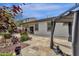 Relaxing backyard oasis with covered patio and lush landscaping at 2126 W Red Fox Rd, Phoenix, AZ 85085