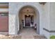 Front entry with arched doorway and sitting bench at 2126 W Red Fox Rd, Phoenix, AZ 85085