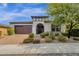 Single story home with brown door and attached two-car garage at 2126 W Red Fox Rd, Phoenix, AZ 85085