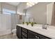 Bathroom boasts a bathtub, double sinks, and dark brown vanity at 2126 W Red Fox Rd, Phoenix, AZ 85085