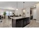 Open kitchen features granite island and breakfast bar at 2126 W Red Fox Rd, Phoenix, AZ 85085