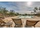 Relaxing community pool with lounge chairs and umbrellas at 2126 W Red Fox Rd, Phoenix, AZ 85085