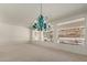 Sunlit dining room with expansive windows and a stylish chandelier at 15210 S 20Th St, Phoenix, AZ 85048