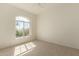 Bright bedroom with neutral carpeting and a large window at 15210 S 20Th St, Phoenix, AZ 85048