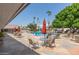 Relaxing pool area with patio furniture and umbrellas at 201 S Greenfield Rd # 324, Mesa, AZ 85206