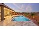 Relaxing pool area with covered patio and comfortable seating at 15175 S 185Th Ave, Goodyear, AZ 85338