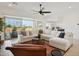 Spacious living room with large sectional sofa and sliding glass doors at 15175 S 185Th Ave, Goodyear, AZ 85338