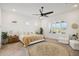 Bright main bedroom with a king-size bed and sitting area at 15175 S 185Th Ave, Goodyear, AZ 85338