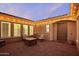 Charming courtyard with brick flooring, fire pit, and string lights at 15175 S 185Th Ave, Goodyear, AZ 85338