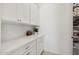 White kitchen features shaker cabinets, quartz countertops and ample storage at 15175 S 185Th Ave, Goodyear, AZ 85338
