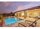 Modern backyard oasis with a large pool and lounge chairs at 15175 S 185Th Ave, Goodyear, AZ 85338