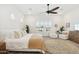 Bright main bedroom with a king-size bed and sitting area at 15175 S 185Th Ave, Goodyear, AZ 85338