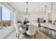 Bright dining room with round table and six chairs, adjacent to the kitchen at 15175 S 185Th Ave, Goodyear, AZ 85338