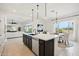 Open concept kitchen with island, stainless steel appliances, and view into living room at 15175 S 185Th Ave, Goodyear, AZ 85338