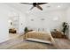 Spacious main bedroom with a king-size bed and sitting area at 15175 S 185Th Ave, Goodyear, AZ 85338