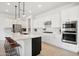 Modern kitchen with white cabinets, stainless steel appliances and a large island at 15175 S 185Th Ave, Goodyear, AZ 85338