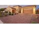 Two-story home with a welcoming front yard and brick driveway at 15175 S 185Th Ave, Goodyear, AZ 85338