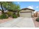 Single-story house with a two-car garage and well-maintained front yard at 16079 W Acapulco Ln, Surprise, AZ 85379