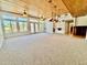 Spacious living room with vaulted ceilings, hardwood floors, and access to backyard at 19422 N 67Th Ln, Glendale, AZ 85308