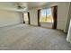 Spacious bedroom with carpeted floors and large windows offering natural light at 19422 N 67Th Ln, Glendale, AZ 85308