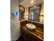Elegant bathroom with a modern vessel sink and wood vanity at 19422 N 67Th Ln, Glendale, AZ 85308