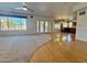 Bright living room with hardwood floors, carpet, and sliding doors leading to a patio at 19422 N 67Th Ln, Glendale, AZ 85308