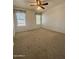 Spacious carpeted bedroom with two windows and ceiling fan at 19422 N 67Th Ln, Glendale, AZ 85308