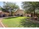 Landscaped backyard with covered patio and grassy area at 19422 N 67Th Ln, Glendale, AZ 85308