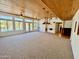 Gathering room with wood ceilings, ceiling fans, and sliding doors leading to a patio and pool at 19422 N 67Th Ln, Glendale, AZ 85308
