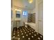 Clean bathroom with pedestal sink, tub, and geometric tile floor at 19422 N 67Th Ln, Glendale, AZ 85308
