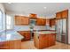 Kitchen features granite countertops, wood cabinets, and an island at 19422 N 67Th Ln, Glendale, AZ 85308