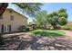 Large backyard with grassy area, mature trees, and a gravel pathway at 19422 N 67Th Ln, Glendale, AZ 85308