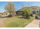 Backyard with pergola, grassy area, and mature trees at 23907 N 83Rd Ave, Peoria, AZ 85383