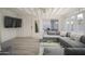 Living area featuring sectional sofa and large TV, with patio view at 5818 N Granite Reef Rd, Scottsdale, AZ 85250